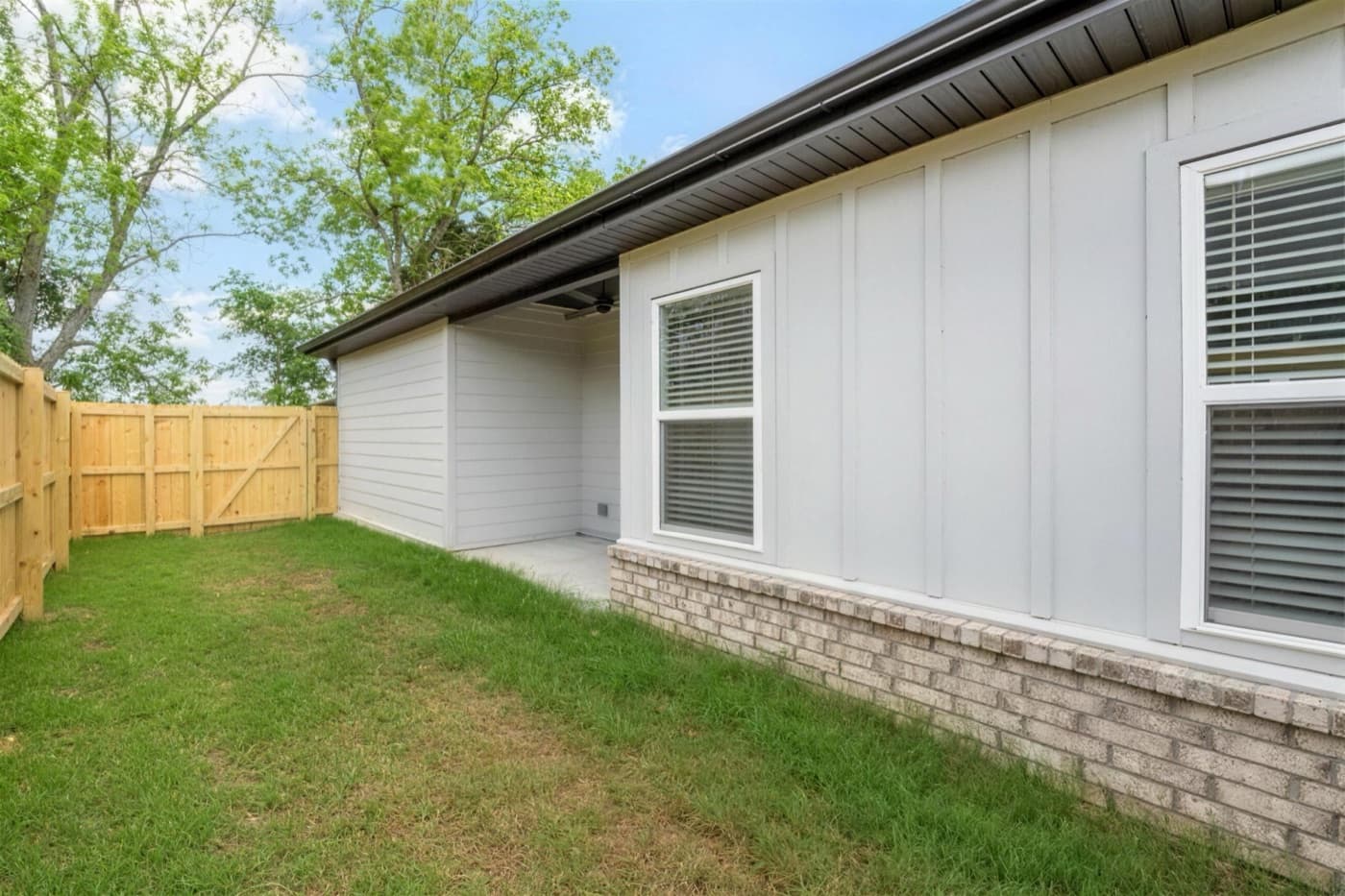 A fenced backyard behind a duplex