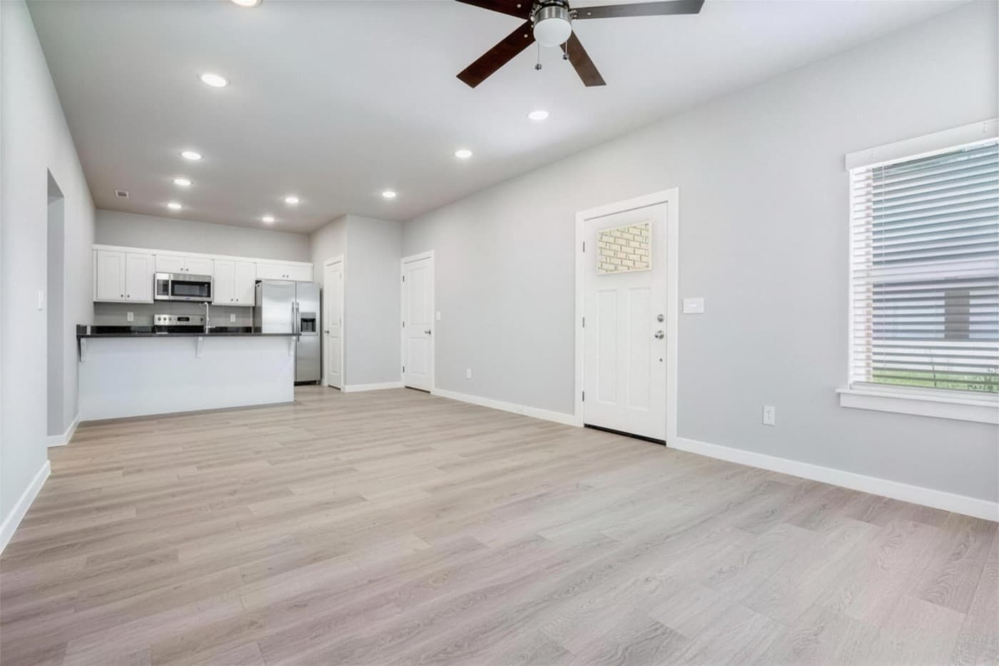An open living room and kitchen with vaulted ceilings